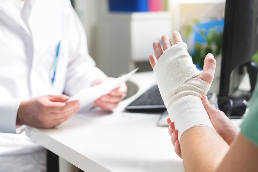 Injured,Patient,Showing,Doctor,Broken,Wrist,And,Arm,With,Bandage